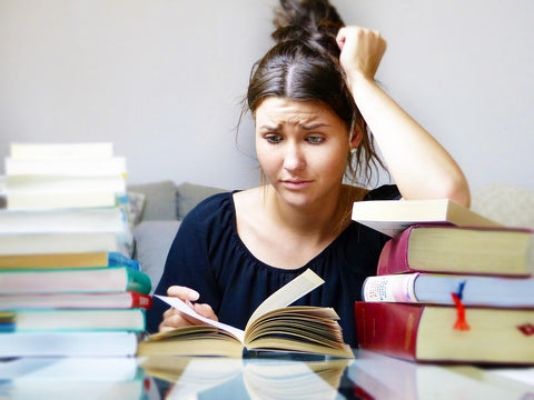 a person overwhelmed by how much reading they have to do