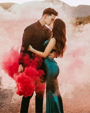 Couple kissing with a smoke bomb photography smoke grenade wrapping around them in red smoke grenade dual vent and single vent