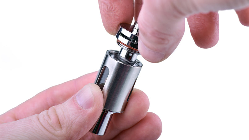 hands unscrewing vape tank