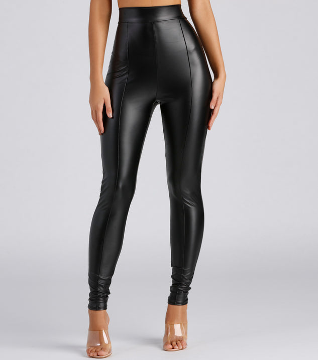 Sleek black faux leather leggings worn with white blouse and gold