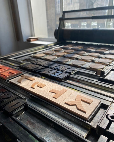 wood block on letterpress bed at the printer's devil