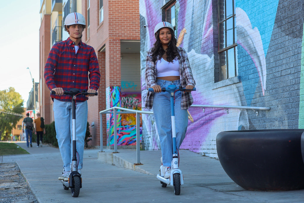 People riding GOTRAX Apex LE Entry Level Electric Scooters