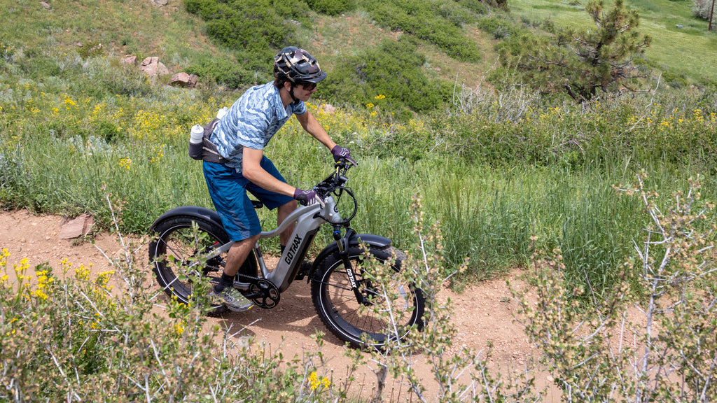 A man riding the GOTRAX Tundra fat tire electric bike in a step over frame style.