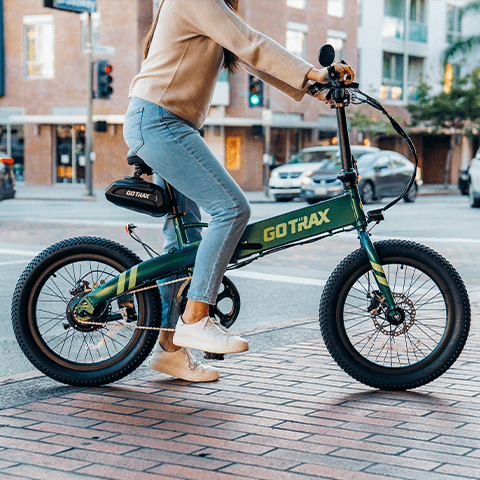 A shot of a woman riding the GOTRAX F1 V2 folding electric bike with simpler starting.