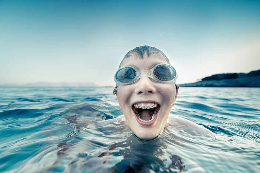 kid with braces swimming