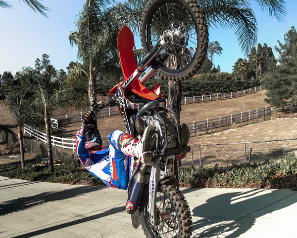 Robbie Maddison poses on his motorbike wearing the eSmartr Scorpion Sleeve.