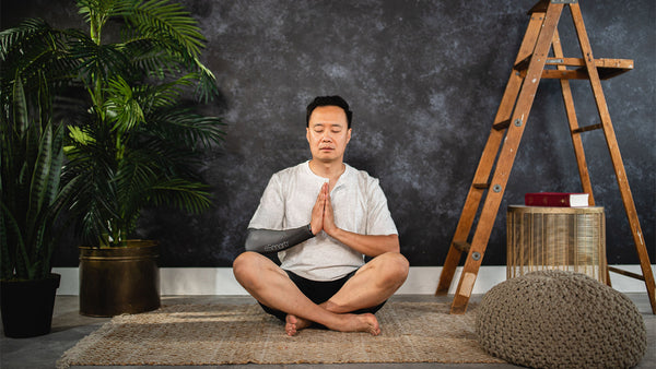 A man meditates at home for natural stress relief.