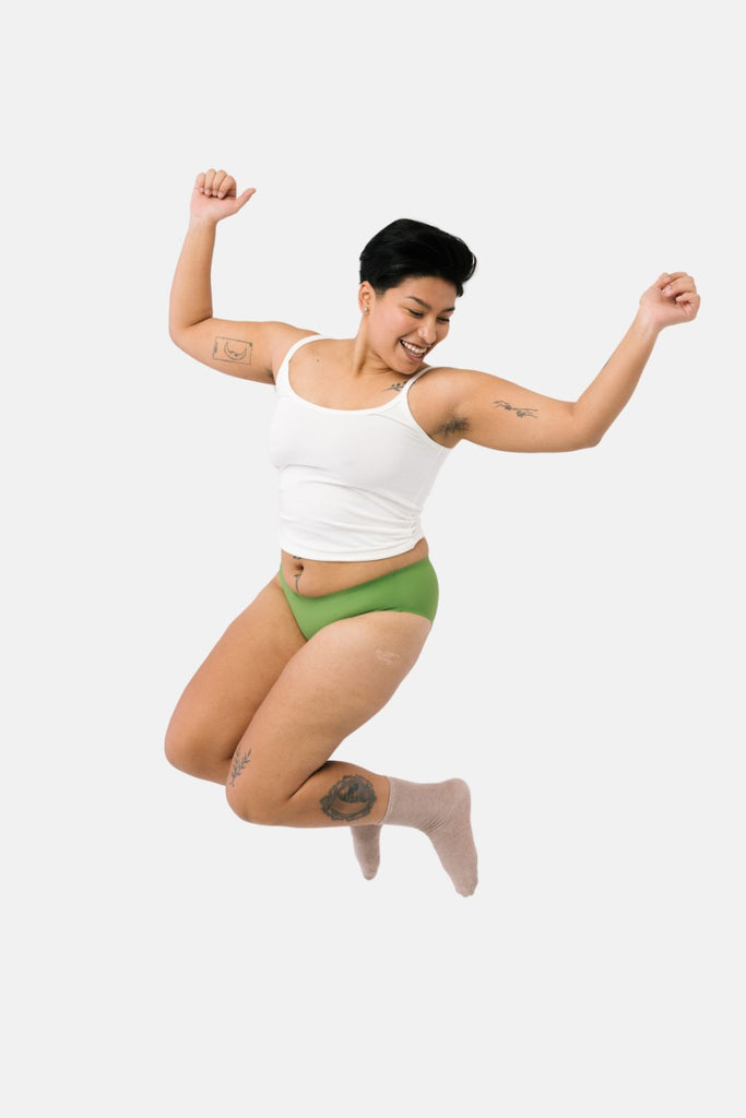 teen jumping in the air wearing leakproof underwear