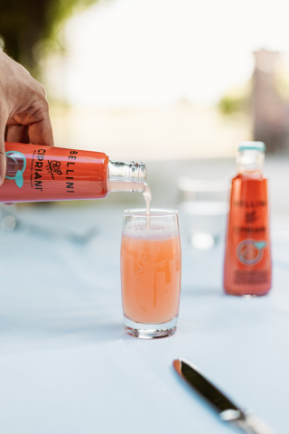 Bellini being poured in a glass