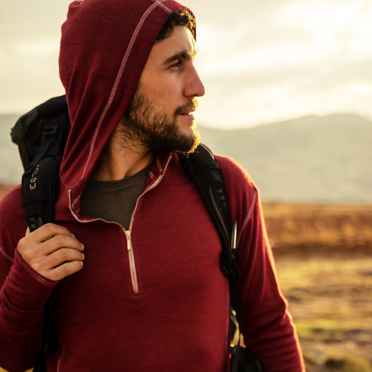 Man hiking, wearing a soft and moisture-wicking alpaca wool hoodie