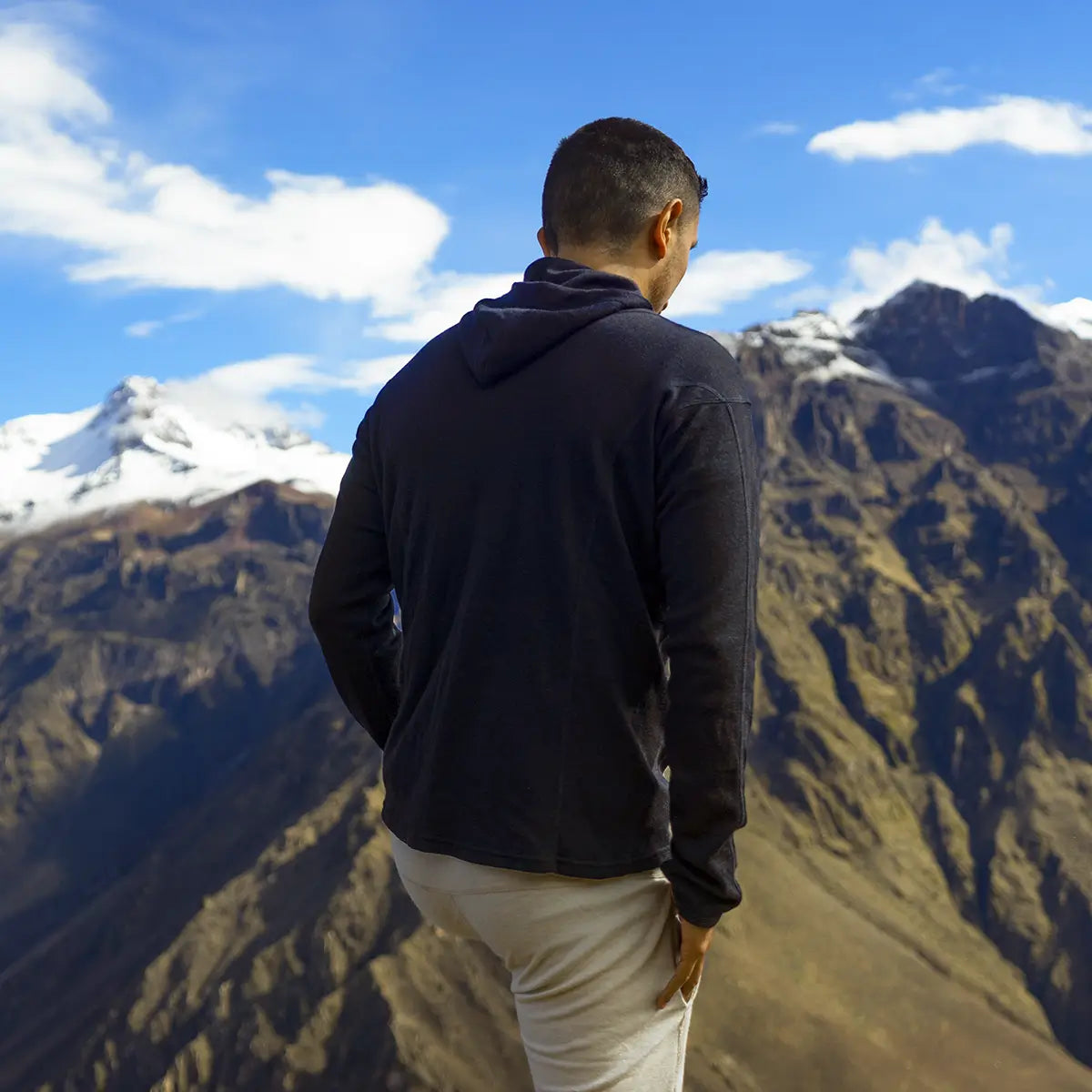 Man wearing alpaca wool hoodie on a hike in the mountains