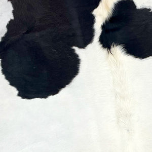 Closeup of this XXL, Brazilian Cowhide that is mostly white, with a few large, black spots  (BRBKW180)