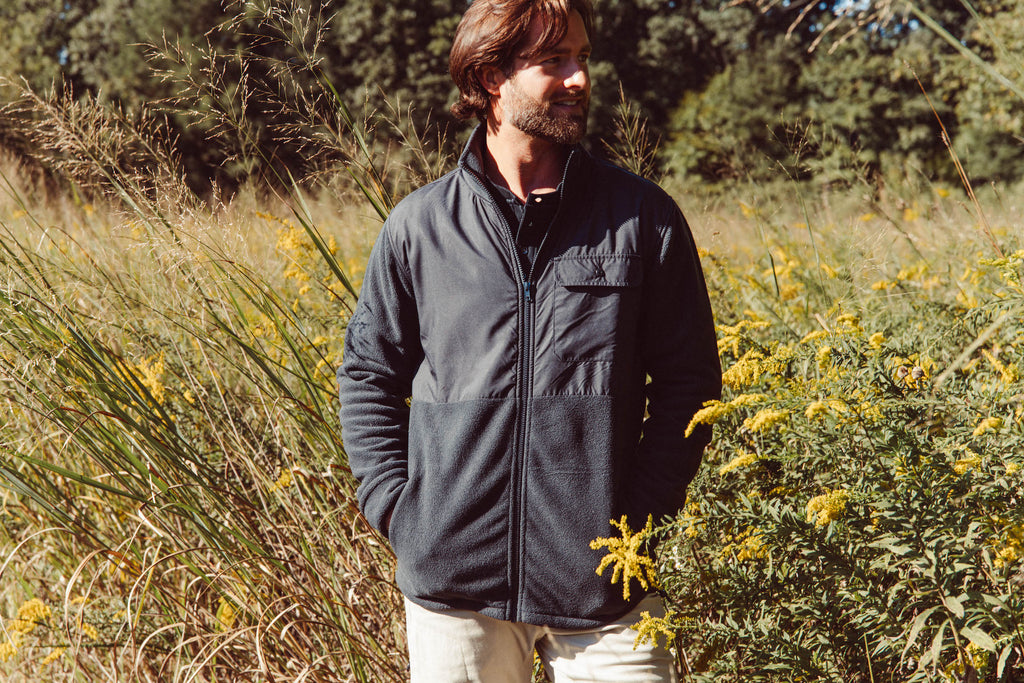 Man wearing Col Jacket in a field