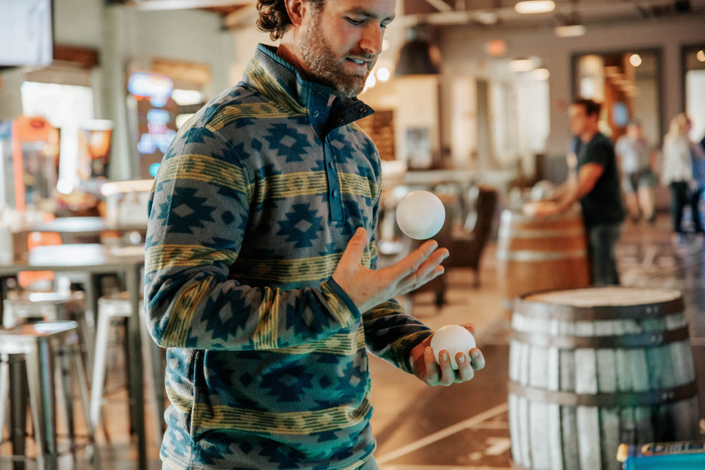 Man playing ball in his hands wearing Col Printed Quarter Snap fleece