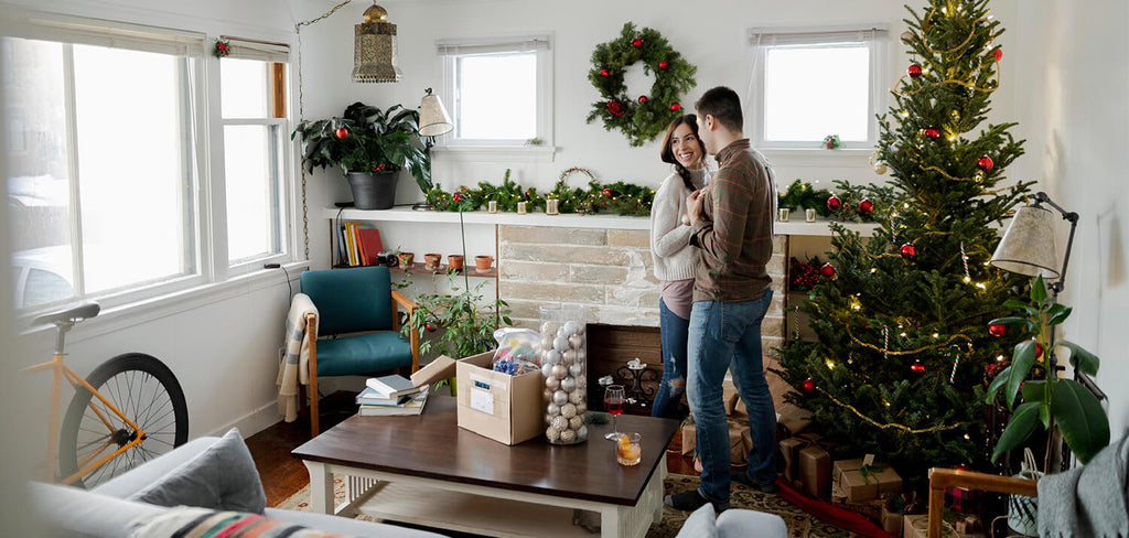 Couple in living room with Christmas Tree