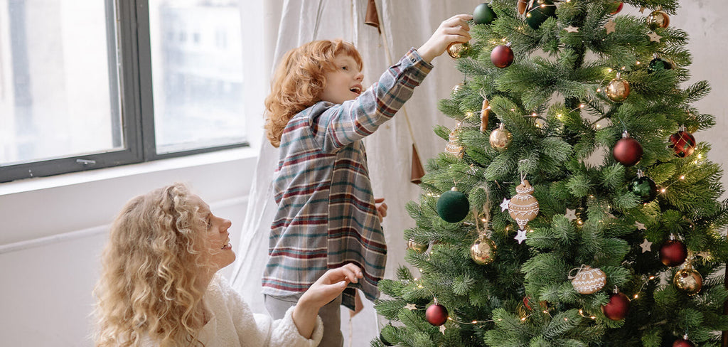 Mother and Son decorationg Christmas Tree