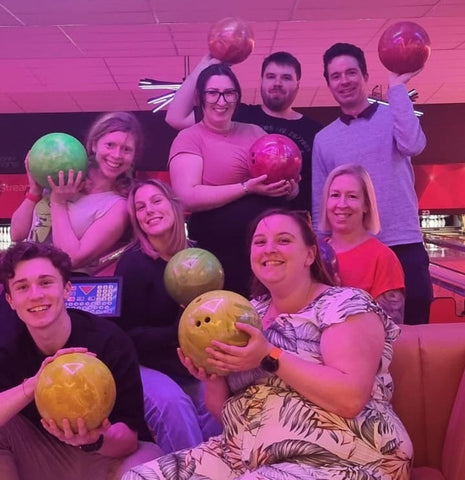 Luna Events Staff photo at bowling ally, each holding bowling ball