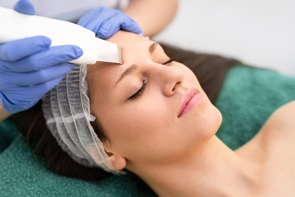 A woman receiving dermaplaning with a razor to discuss dermaplaning side effects