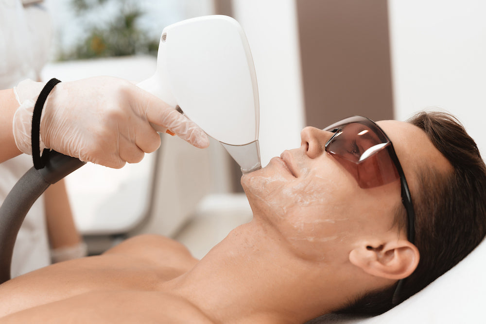 Men's Facials: a man receiving a laser hair removal treatment