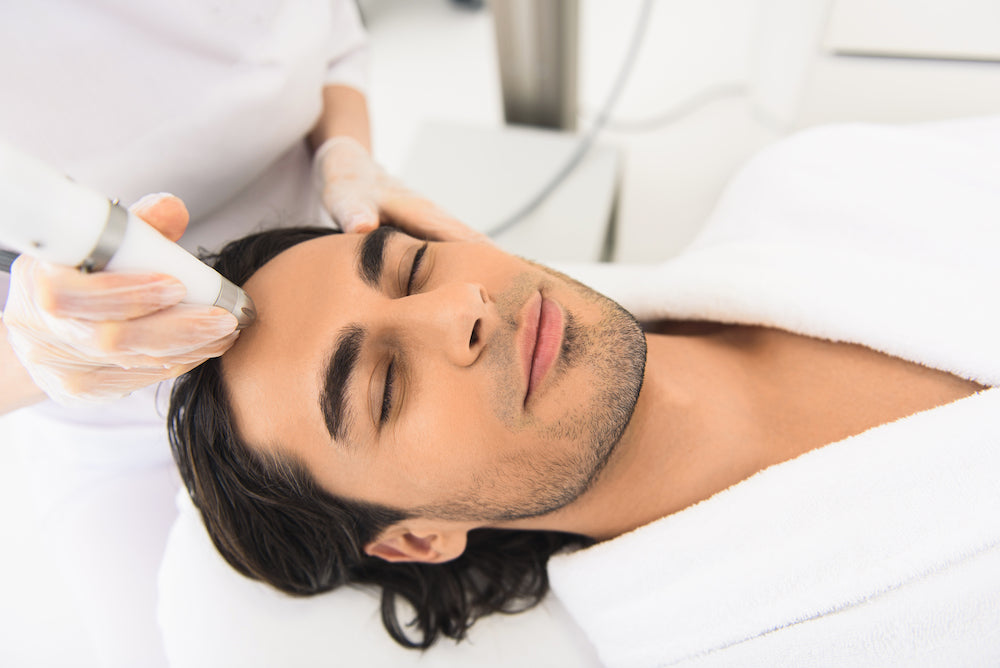 Men's Facials: a man receiving a cosmetic treatment at a medi-spa
