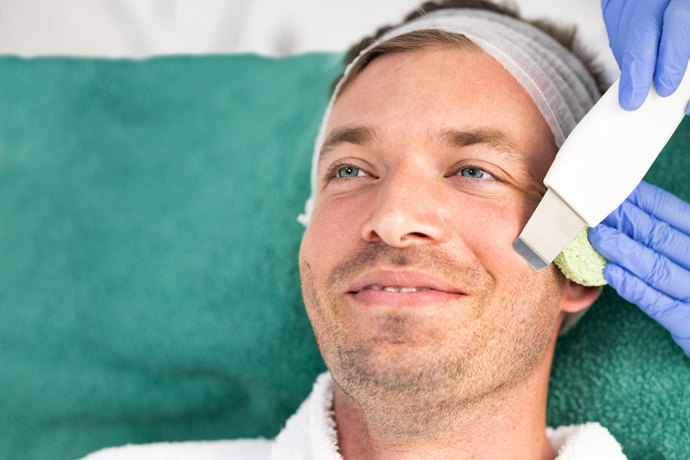 Men's Facials: a man receiving microdermbrasion or dermaplaning treatment