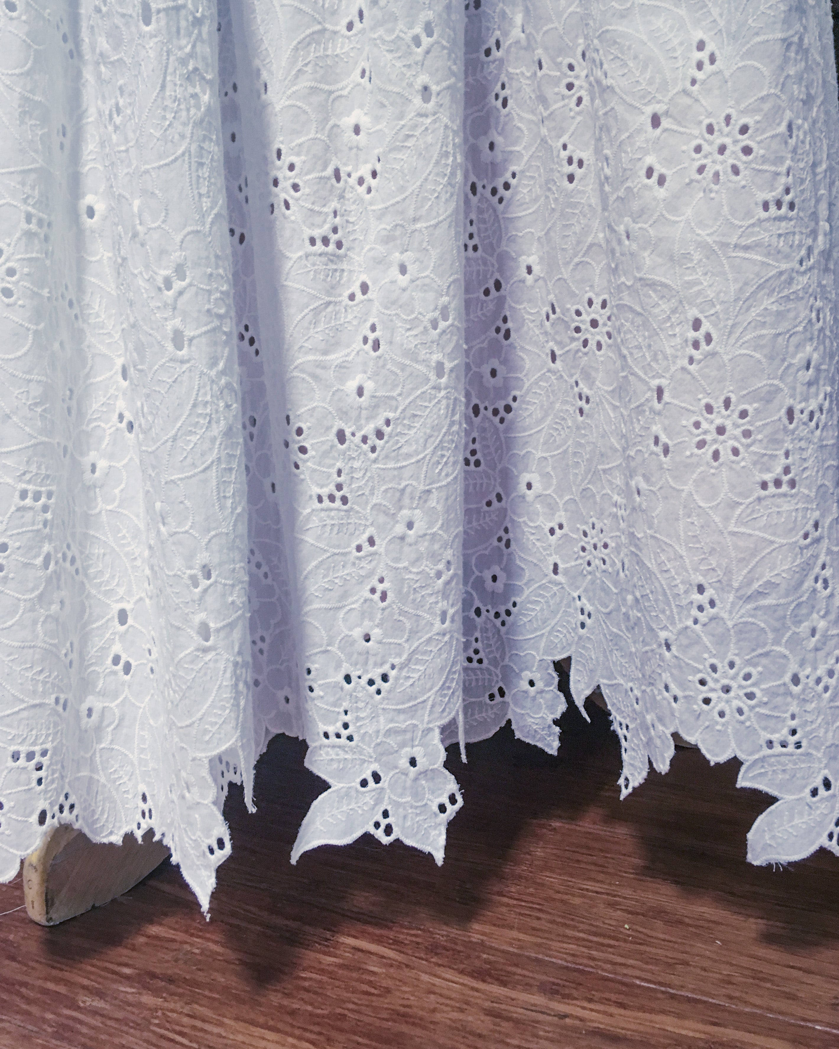 Broderie anglaise fabric with trimmed hem 