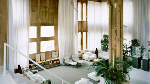 La Fábrica's grand living room with floor to ceiling windows and white translucent curtains