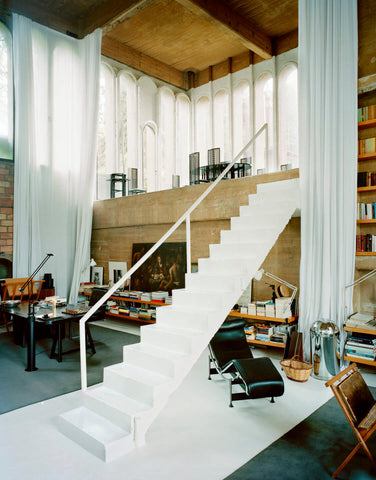 The main office at La Fábrica with a white exposed staircase in the center
