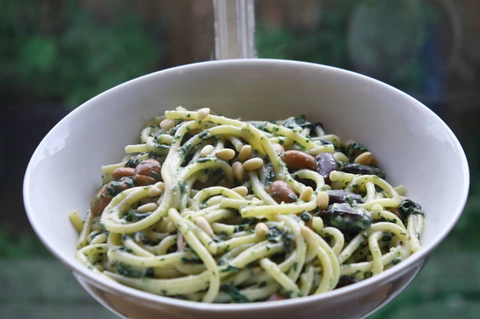 vegan creamy spinach pasta in bowl by window