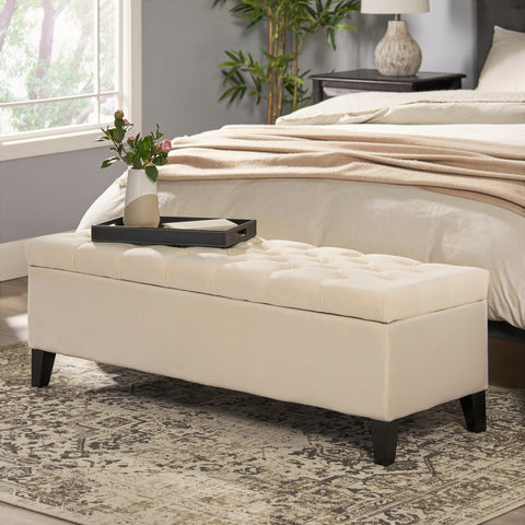 Ivory velvet storage ottoman bench at the end of a bed