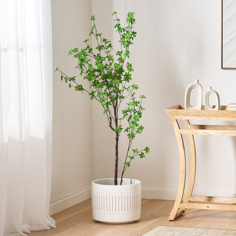 Artificial Enkianthus Tree in the corner of a room, in between a window and a console table