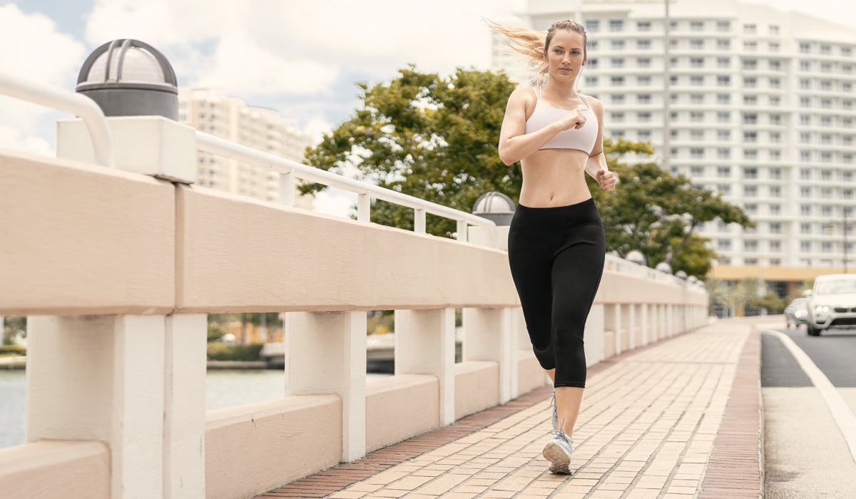 woman running and sweating with her Copper Slim Pants
