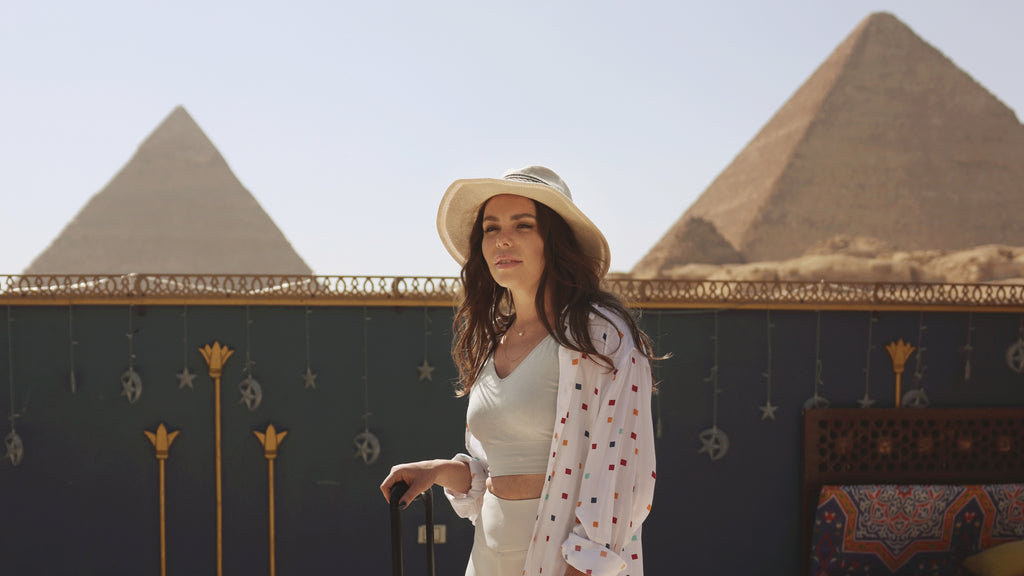 woman traveling in Egypt, pyramids in the background