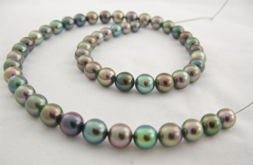 Colorful Tahitian pearls being strung