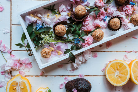 Manuka honey bliss balls on a platter with flowers