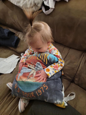 Melissa’s daughter cherishing one of the memorial t-shirt pillows.