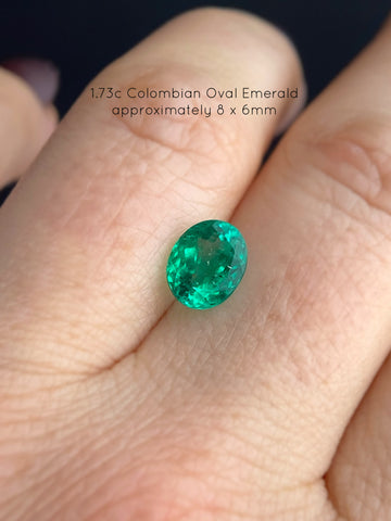 Loose Colombian Emerald before setting shows it's natural ethereal glow under a gem light