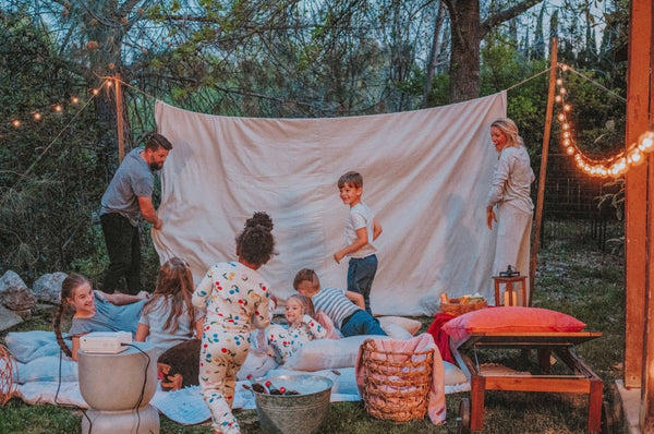 10 Things to Do Before School Starts (For Families). Family of eight setting up a home theatre in their backyard.