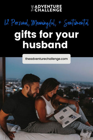 Couple sitting on the bed and looking through a scrapbook; image overlaid with text that reads 12 Personal, Meaningful, & Sentimental Gifts for your Husband