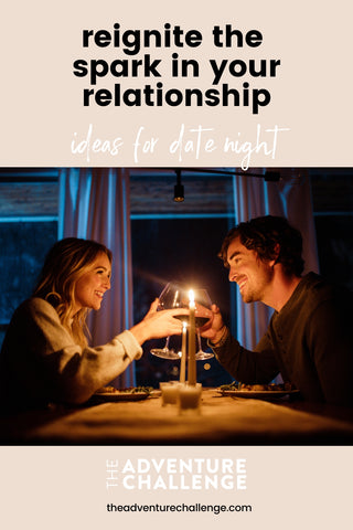 Couple smiling at each other during candlelit dinner; image overlaid with text that reads Reignite The Spark In Your Relationship Ideas For Date Night