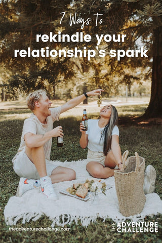 Guy feeding the girl grapes as they enjoy a lovely picnic together; image overlaid with text that reads 7 Ways to Rekindle Your Relationship's Spark