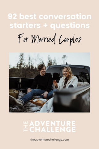 Couple laughing with each other as they sit on the back of a truck; image overlaid with text that reads 92 Best Conversation Starters + Questions For Married Couples