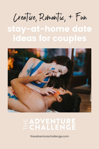 Couple lying on the floor and applying face paint to each other; image overlaid with text that reads Creative, Romantic, and Fun Stay-at-Home Date Ideas for Couples