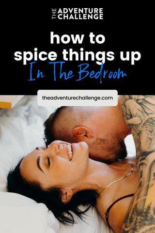 Boyfriend kissing her girlfriend on the neck as she smiles while lying down in bed; image overlaid with text that reads How To Spice Things Up In The Bedroom