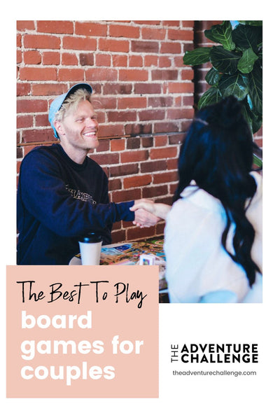 Couple shaking hands after playing a round of board games; image overlaid with text that reads The Best Two Play Board Games for Couples