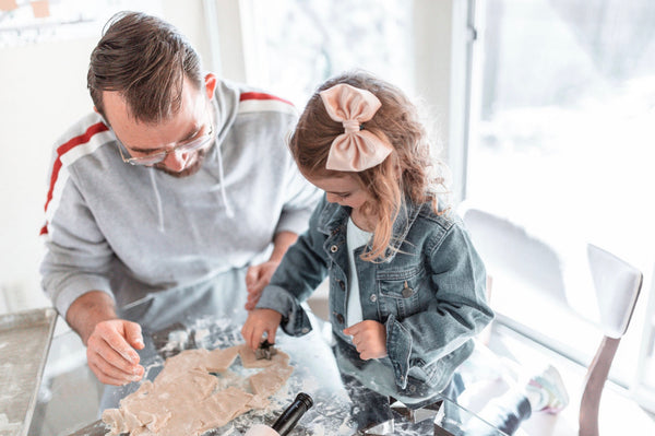 Little girl baking and making cookies with her father
