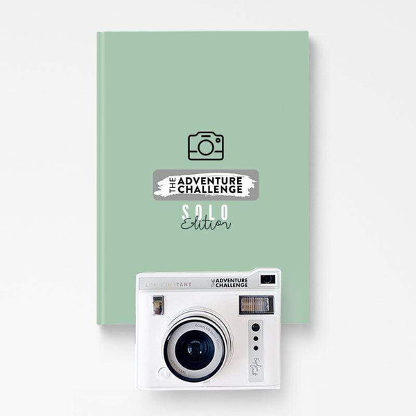 White polaroid camera and the Adventure Challenge Book, a perfect gift for an adventurer