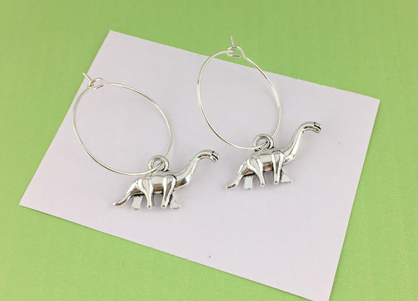 A pair of silver dinosaur earrings, a fun and quirky birthday gift for her