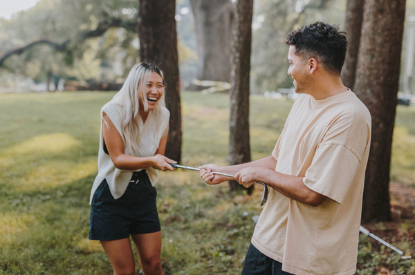 55 Cheap Date Ideas That Are Fun And Create Connection. Couple sharing laughs during their golf date.