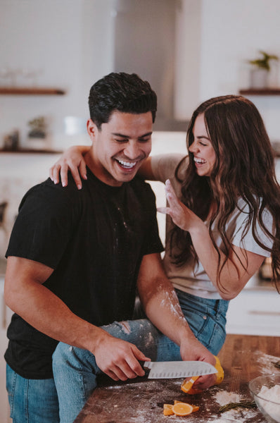 55 Cheap Date Ideas That Are Fun And Create Connection. Couple sharing laughs as they cook together in the kitchen.